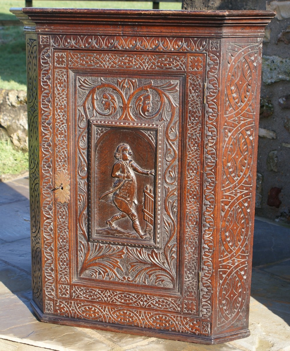 a fine example of a victorian gothic revival oak corner cupboard